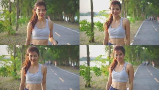 肖像快乐的亚洲年轻美丽的女人站在傍晚日落在大街上的公园。健身健硕的运动员在户外进行慢跑健身运动，以保持身体健康。高清在线视频素材下载