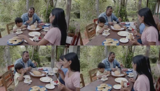 一对幸福的夫妇和他们的两个孩子在农场享受美味的早餐高清在线视频素材下载
