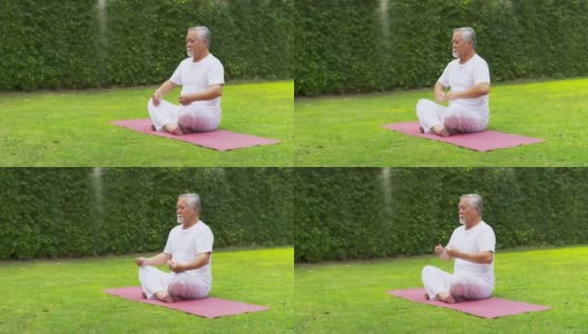 亚洲老人在花园里做瑜伽。高清在线视频素材下载