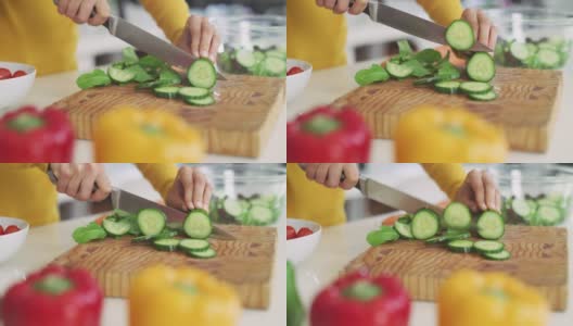 一个不认识的人在家里的厨房里切黄瓜的4k视频高清在线视频素材下载