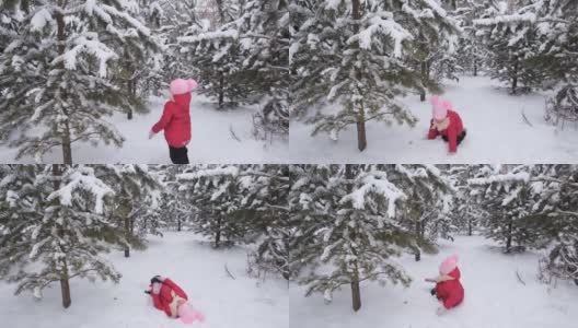 冬天，小女孩在公园里玩耍，在雪地里蹦蹦跳跳，打滚，抖落树枝上的雪高清在线视频素材下载