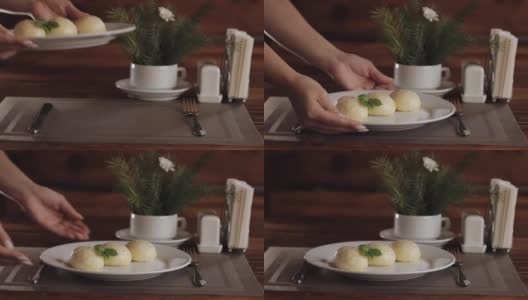 服务员的手放在桌上的传统菜Gombovtsi奶酪饺子高清在线视频素材下载