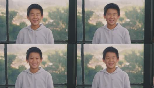 快乐和自信的混血亚洲男孩微笑，十几岁的肖像高清在线视频素材下载