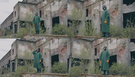 废墟上戴着防护面具的人。戴着防毒面具的男子在废墟附近的戏剧性肖像高清在线视频素材下载