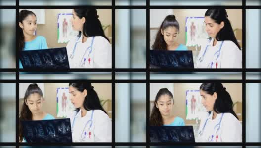 拉丁女医生拿着病人的x光片。她正在给年轻的拉丁女病人做体育检查。高清在线视频素材下载