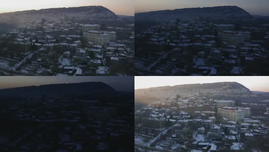 一个冬天的日落在一个古老的山城的城市风景和彩色的房子爬上了山。高清在线视频素材下载