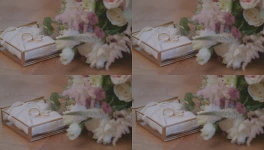结婚戒指装饰盒与鲜花背景。高清在线视频素材下载