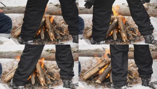 在冬天的森林里，人们围着火堆取暖高清在线视频素材下载
