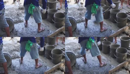 Construction working shoveling Concrete Grout poured from concrete mixer高清在线视频素材下载