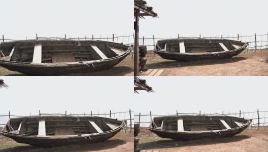 生锈的旧木船。海滩上被遗弃的旧划艇。视频。海滩上的一条旧船高清在线视频素材下载