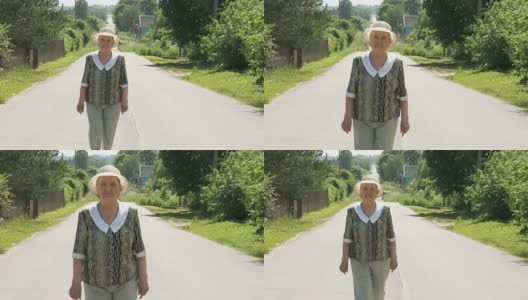 一位老妇人走在村里的路上高清在线视频素材下载