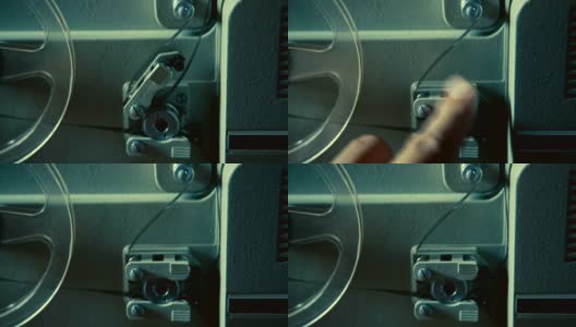 男性的手修复旧电影放映机上的电影高清在线视频素材下载