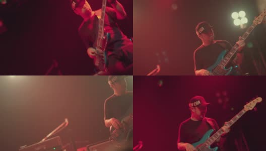 亚洲男子吉他手表演在夜总会的舞台上与摇滚乐队。高清在线视频素材下载