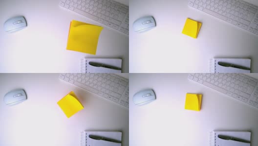黄色的帖子掉在办公桌上高清在线视频素材下载