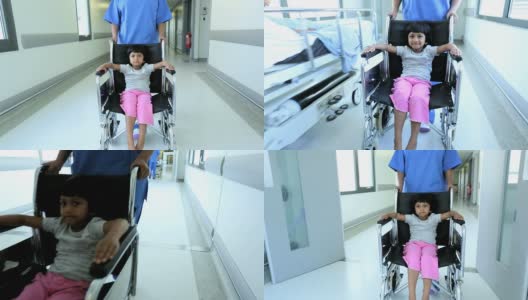 小女孩轮椅推着繁忙的医院走廊高清在线视频素材下载