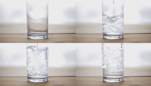 水从瓶子倒进木桌上的玻璃杯里高清在线视频素材下载