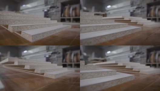细木工店里的工作台上放着切好的刨花板，这是家具厂的移动特写镜头高清在线视频素材下载