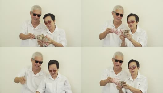 快乐，有钱，酷，有钱的亚洲老年人。向空中扔钱高清在线视频素材下载