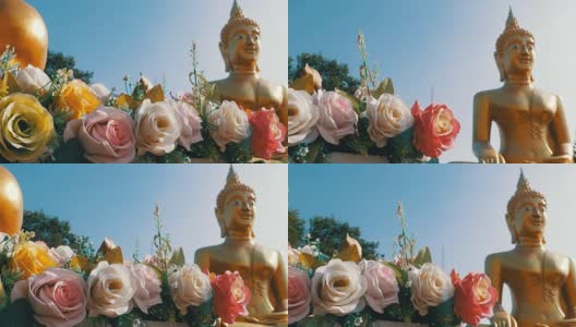 Flowers on a background of a large golden Buddha in the temple of Thailand. Pattaya高清在线视频素材下载
