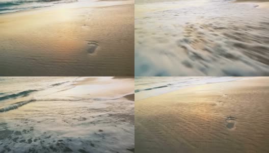 夕阳的海浪把脚印冲刷在金色的沙滩上高清在线视频素材下载