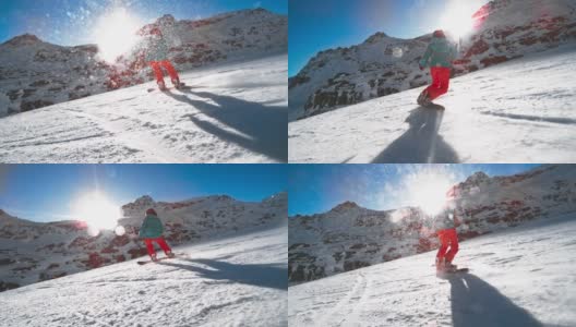 SLO MO TS女滑雪板在一个斜坡上，太阳在山的后面照耀高清在线视频素材下载