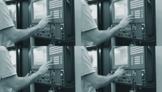 在生产机器的控制面板后面工作的人高清在线视频素材下载