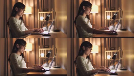 亚洲女性晚上在家里使用笔记本电脑高清在线视频素材下载