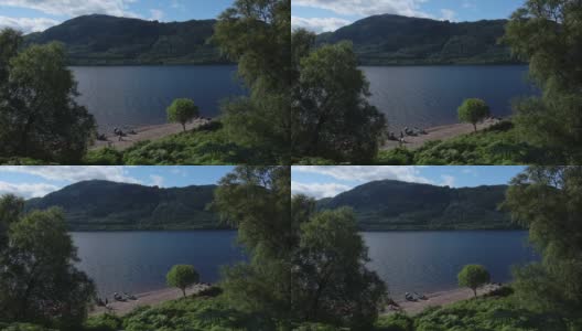 尼斯湖景观后的一些树木，苏格兰，以山为背景高清在线视频素材下载
