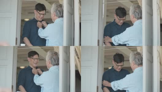 年迈的父亲和成年的儿子在家里聊天，慢镜头高清在线视频素材下载