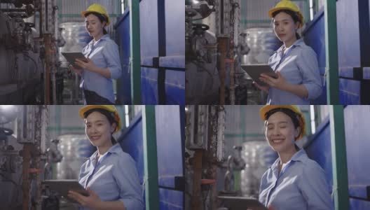 工厂里微笑的年轻女操作员高清在线视频素材下载