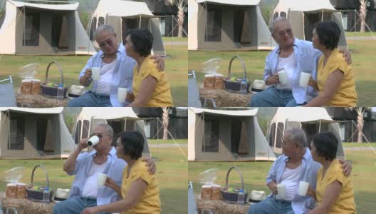 亚洲老夫妇坐在露营放松和喝一杯咖啡高清在线视频素材下载