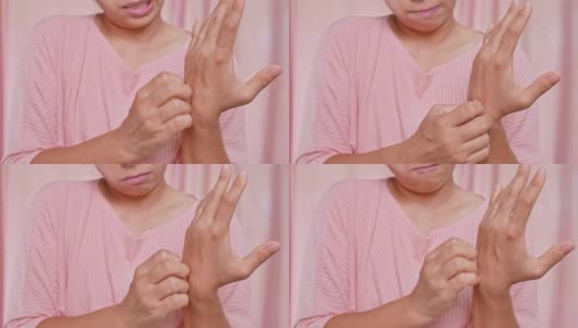 恼怒的中年妇女抓挠她的手瘙痒干燥皮肤，湿疹，皮炎，过敏，牛皮癣。保健和皮肤病的概念。高清在线视频素材下载