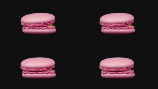 粉红色马卡龙旋转在黑色背景。食品的概念。糖果在唱机转盘上靠近高清在线视频素材下载