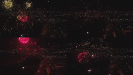 烟花在城市的夜空中绽放。从无人机拍摄的特写镜头。4 k的视频。高清在线视频素材下载