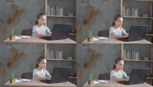 十几岁的女学生在家里用笔记本电脑做作业。这个孩子使用电子设备学习。儿童教育和远程学习。高清在线视频素材下载