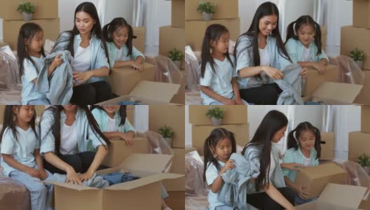 亚洲母女在室内用移动箱子包装衣服高清在线视频素材下载