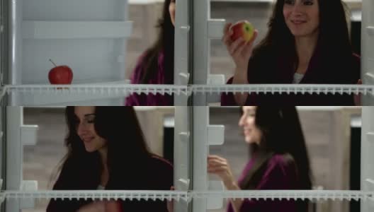 从冰箱里拿苹果的女人高清在线视频素材下载