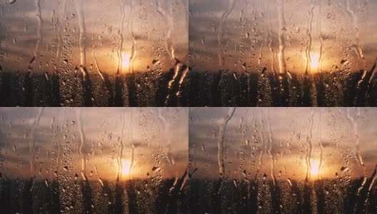 美丽的日出，同时下雨。在窗户后面看日出。4 k高清在线视频素材下载