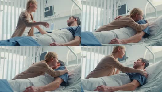 在医院里，快乐的妻子探望躺在床上正在康复的丈夫。他们充满爱意地拥抱和微笑。高清在线视频素材下载