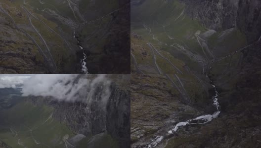 4K鸟瞰图瀑布流下悬崖的Trollstigen路与山区森林高清在线视频素材下载