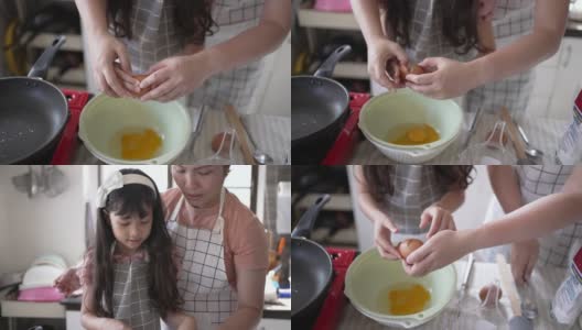 快乐的妈妈和女儿正在家里的厨房里做煎饼高清在线视频素材下载