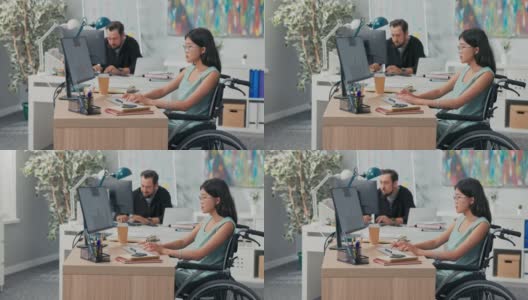 工作日在办公室，公司，公司，同事们都在电脑前工作，起草文件，一个戴着眼镜的亚洲美女坐在轮椅上，她是残疾人，事故后高清在线视频素材下载