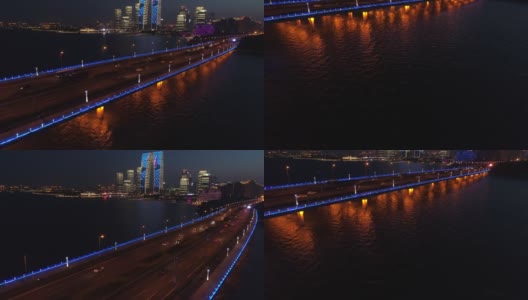 现代城市中桥的鸟瞰图，带照明的桥的全景。河上大桥夜间交通鸟瞰图。高清在线视频素材下载