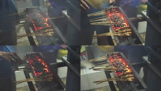巴厘岛库塔，一名厨师在街上准备肉串高清在线视频素材下载