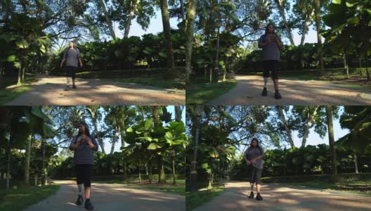 亚洲印度女性截肢与义肢行走，同时使用手机在公园高清在线视频素材下载