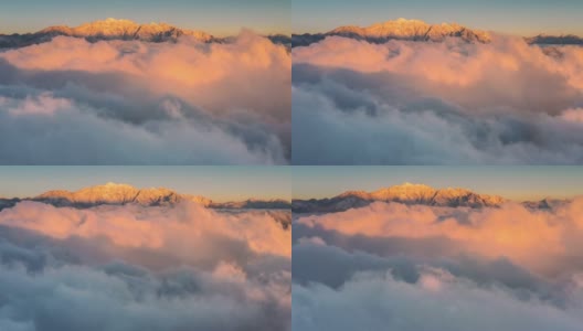 日出时，云海在雪山前翻滚，显得格外壮观高清在线视频素材下载