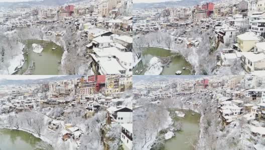 鸟瞰图的城市景观在冬天与白雪覆盖的屋顶和蜿蜒的河床高清在线视频素材下载