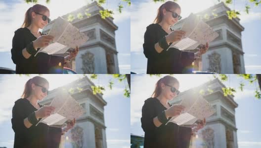 游客站在巴黎凯旋门前，阅读城市地图高清在线视频素材下载