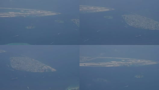 从飞机上俯瞰马尔代夫的一个热带岛屿的海滩，这里有白色的沙滩和水上小屋。高清在线视频素材下载