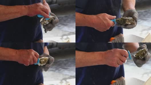 一名男子在关闭的市场打开新鲜的牡蛎高清在线视频素材下载